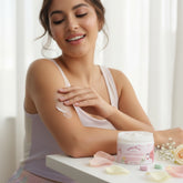 User applying Island Rose collagen body butter on her arm, showcasing the product&